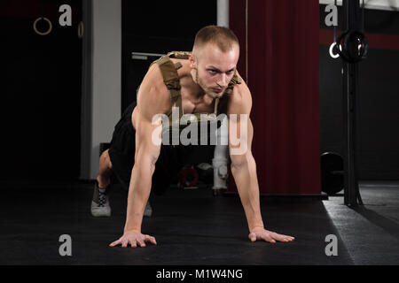 Close-up Of A Young Male Bodybuilder Doing Push-ups In Gym Stock Photo