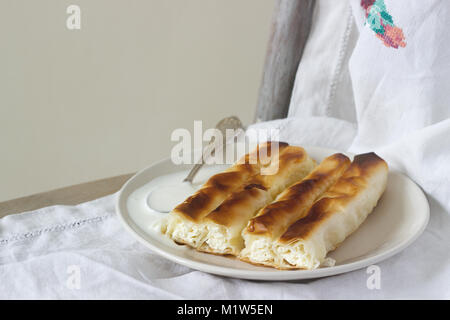 Vertuta or placinta with cottage cheese and cheese with sour cream. Traditional Moldovan, Romanian or Balkan pie. Stock Photo