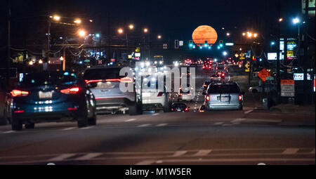 Metro Atlanta commuters in rush hour traffic as a full moon rises above US Highway 78 in Snellville, Georgia. (USA) Stock Photo