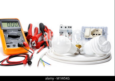 Multimeter, work tools and components for a residential electrical installation, photographed on a white background. Stock Photo