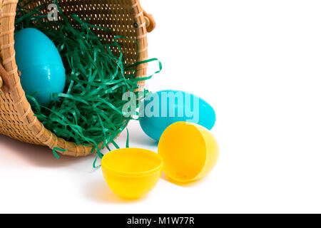 Plastic Easter eggs in basket on white Stock Photo