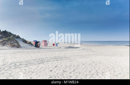 North Sea beach on the island of Borkum with beach chair and a blue sky Stock Photo