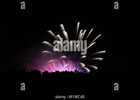Huge colourful explosion of fireworks in different colours at magic event Stock Photo