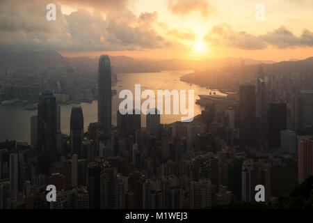 Sunrise over Hong Kong Victoria Harbor from Victoria Peak with Hong Kong and Kowloon below. Stock Photo