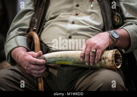 Dortmund, Germany. 2nd Feb, 2018. A contestant rest his instrument on his lap at the 20th German Championship of Stag-Calling in Dortmund, Germany, 2 February 2018. The art of stag-calling is part of the traditional vocation of the huntsman. Credit: Bernd Thissen/dpa/Alamy Live News Stock Photo