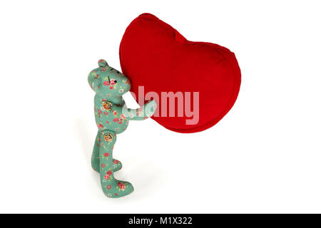Green Teddy bear holds in paws big red heart Stock Photo