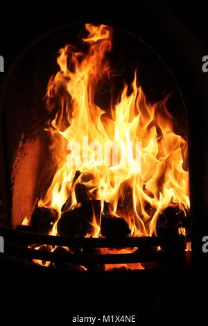 Coal Fire burning in domestic grate or fireplace or fire place at home Stock Photo
