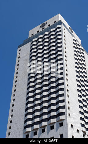 Izmir, Turkey - April 22, 2012: The modern building of the Hilton hotel against the blue sky in the city of Izmir. The five-star Hotel Hilton is locat Stock Photo