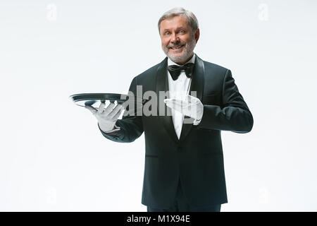 Senior waiter holding tray Stock Photo