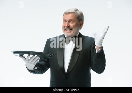 Senior waiter holding tray Stock Photo