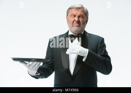 Senior waiter holding tray Stock Photo