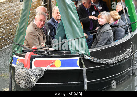 The Prince of Wales rides on a canal boat through a lock as he officially opens the first phase of the restored Cotswold Canals at Wallbridge Upper Lock, Wallbridge, Stroud and meets volunteers from the project and members of the local community undertaking activities on the canal. Stock Photo