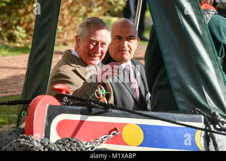 The Prince of Wales rides on a canal boat as he officially opens the first phase of the restored Cotswold Canals at Wallbridge Upper Lock, Wallbridge, Stroud and meets volunteers from the project and members of the local community undertaking activities on the canal. Stock Photo