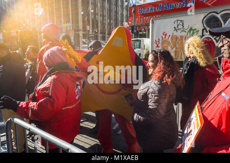 The Carl's Jr. mascot entertains the crowd on line waiting to get into the Carl's Jr. location in Midtown Manhattan in New York on its grand opening, Wednesday, January 31, 2018. The fast food chain with over 1300 restaurants is entering the competitive New York market. The chain, operated by CKE Restaurant Holdings (which also owns the Hardee's brand) has less than 10 of its franchises east of Oklahoma. (Â© Richard B. Levine) Stock Photo