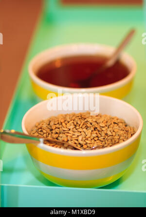 Sunflower core in a porcelain bowl as nutritionist food, with shallow depth of field and selective focus. Great background for nutritionist concept. Stock Photo
