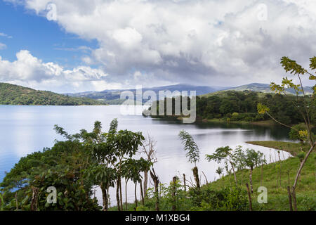 beautiful scene with a relaxing lake view and a tropical rainforest surrounding lake Arenal in Costa Rica Stock Photo