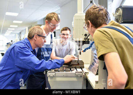 Group of young people in technical vocational training with teacher Stock Photo