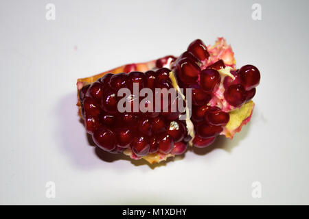 It is a Pomegranate.It is a glossy red fruit.so yummy Stock Photo