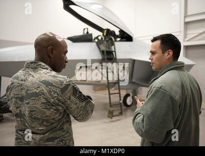 Tech. Sgt. Ryan Hehl, an instructor supervisor in the 365th Training Squadron's F-22 avionics apprentice course, tells Chief Master Sgt. of the Air Force Kaleth O. Wright about the trainer used to teach Airmen their craft Jan. 25, 2018. F-22 maintenance training one of many diverse courses taught at Sheppard Air Force Base, Texas. The CMSAF's visit was part of a two-day immersion tour of the base. (U.S. Air Force Stock Photo