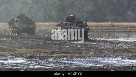 U.S. Soldiers from Kronos Troop, 3rd Squadron, 2nd Cavalry Regiment, drive their Strykers to their battle positions as they participate in a mounted NATO live fire exercise coordinated by the Polish 1st Battalion 15th Mechanized Brigade at a range near the Bemowo Piskie Training Area, Poland, Jan. 30, 2018. The unique, multinational battle group, comprised of U.S., U.K., Croatian and Romanian soldiers serve with the Polish 15th Mechanized Brigade as a deterrence force in northeast Poland in support of NATO’s Enhanced Forward Presence. (U.S. Army Stock Photo