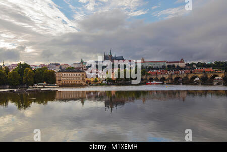 High angle panorama view of Prague old town, Charles Bridge, Royal castle and Saint Vitus Cathedral over Vltava river and cloudy sky sunny day