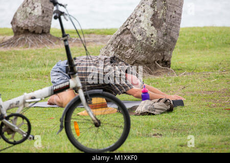 Man in Rex smeal park in Port Douglas doing yoga,Queensland,Australia Stock Photo