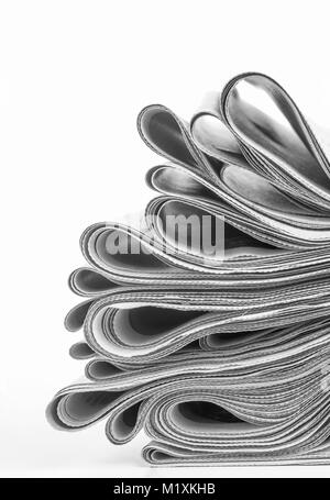 Newspapers folded and stacked on white background Stock Photo