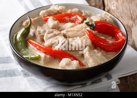 Spicy Bicol Express with chili, coconut, garlic, onion and ginger close-up in a bowl on the table. horizontal Stock Photo