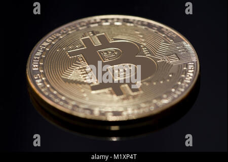 Gold Bitcoin on gloss black background Stock Photo