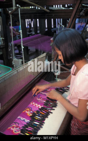 Myanmar. Bagan (Pagan). Silk industry. Woman weaving silk in silk factory. Stock Photo