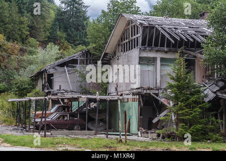 Old Pickup Truck And Debris In Front Of House Heavily Hit By Stock