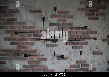 Post modern designed light bulbs on the ruined brick wall Stock Photo