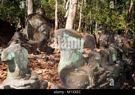 Ancient outdoor Buddhas field of broken sculpture in Wat Umong Suan Puthatham.The temple is a 700 year was built in 1297 in Chiang Mai city, Thailand. Stock Photo