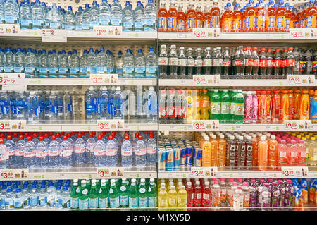 Shelves with soft drinks and water in an airport branch of Boots.