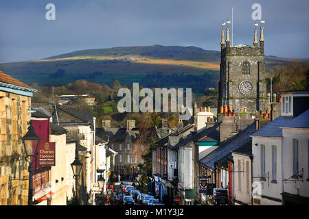 View looking down West Street in Tavistock, Devon, showing Tavistock Parish Church, with Dartmoor National Park in the background. Stock Photo