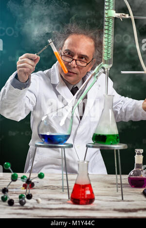ragged chemist in lab doing experiment Stock Photo