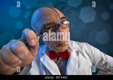 scientist in a white coat doing analyze looking through a magnifying glass Stock Photo