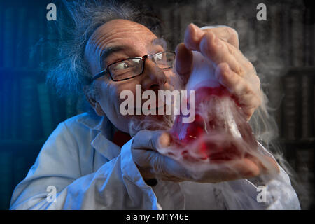 deranged scientist obsessed looking at his  experiments Stock Photo