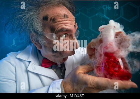 crazy scientist hysteric looking at exploded experiment Stock Photo