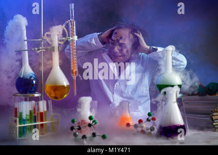 Disappointed chemist looking in his failed experiment in smoke of explosion Stock Photo