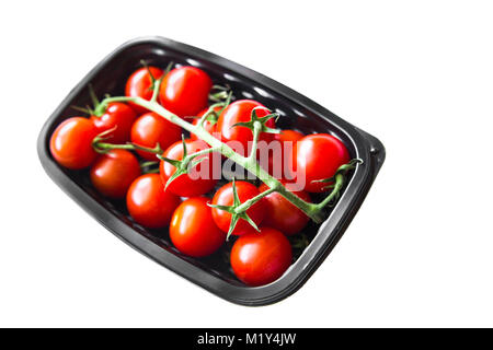 Ripe cherry tomatoes in plastic container against a white background Stock Photo