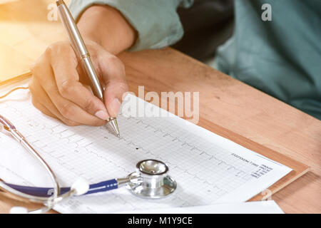 Close-up Of Male Doctor Filling The Medical Form Stock Photo