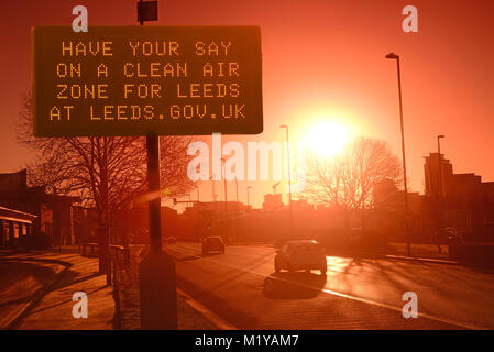 traffic passing digital advert asking for public consultation on a clean air zone for leeds city centre yorkshire united kingdom Stock Photo