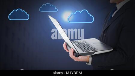 Hand holding tablet with cloud icons Stock Photo