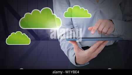 Hand holding tablet with cloud icons Stock Photo