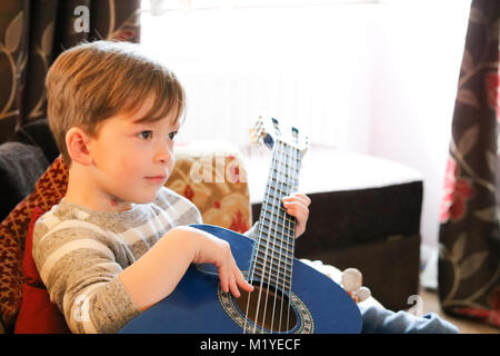 Young boy playing guitar Stock Photo