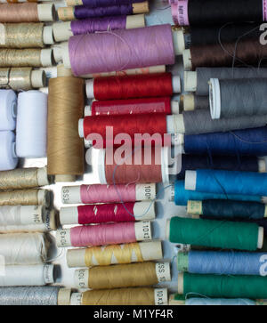 Sewing - coils of colored woolen threads in a metal box. Stock Photo