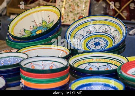 hand-painted dishes of a multitude of colors in a traditional art market Stock Photo