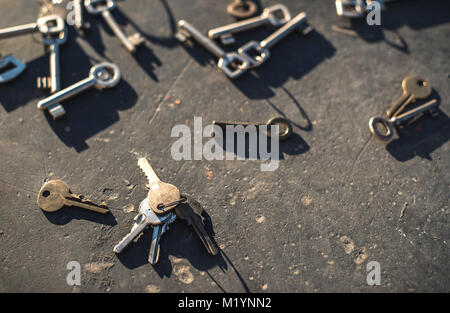 Many Keys on dark table. Sunlight Stock Photo
