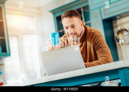 Positive nice man holding a cup Stock Photo